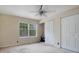 This bedroom features neutral walls, a ceiling fan, and a window bringing in plenty of natural light at 754 E Michigan St # 182, Orlando, FL 32806