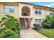Condo exterior with plants, grassy areas, wooden steps and an arched entry way at 754 E Michigan St # 182, Orlando, FL 32806