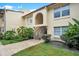 Condo exterior with plants, grassy areas, wooden steps and an arched entry way at 754 E Michigan St # 182, Orlando, FL 32806