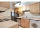 Kitchen with appliances and light wood cabinets at 754 E Michigan St # 182, Orlando, FL 32806