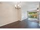 Living room with chandelier, tiled floor and sliding doors to outdoor balcony at 754 E Michigan St # 182, Orlando, FL 32806