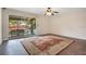 Living room with a ceiling fan, carpeted floor, sliding doors leading to balcony and pool view at 754 E Michigan St # 182, Orlando, FL 32806