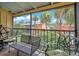 An outdoor seating area on the patio provides a relaxing space to enjoy the lush green views at 754 E Michigan St # 182, Orlando, FL 32806