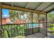 View of the patio with black metal furniture with cushions overlooking the community pool area at 754 E Michigan St # 182, Orlando, FL 32806