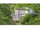 Aerial shot showcasing the home, patio, and surrounding greenery at 7838 Sloewood Dr, Mount Dora, FL 32757