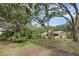 Spacious backyard with mature trees, gazebo, and a view of the house at 7838 Sloewood Dr, Mount Dora, FL 32757