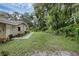 Sprawling backyard features well-manicured lawn, garden beds and mature trees at 7838 Sloewood Dr, Mount Dora, FL 32757