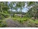 Secluded backyard with lush vegetation, a gazebo and mature trees offering shade and privacy at 7838 Sloewood Dr, Mount Dora, FL 32757