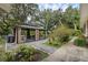 Serene backyard with garden, mature trees, and a cozy gazebo at 7838 Sloewood Dr, Mount Dora, FL 32757
