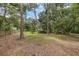 Spacious backyard with mature trees and a fence line at 7838 Sloewood Dr, Mount Dora, FL 32757