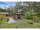 Backyard with a garden and covered gazebo, perfect for outdoor relaxation at 7838 Sloewood Dr, Mount Dora, FL 32757