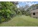Lush backyard area with seating and well-manicured lawn at 7838 Sloewood Dr, Mount Dora, FL 32757