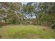 Beautiful backyard with mature trees surrounding the home at 7838 Sloewood Dr, Mount Dora, FL 32757