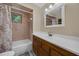 Bathroom featuring tub with shower, window, and a vanity sink with updated countertop at 7838 Sloewood Dr, Mount Dora, FL 32757