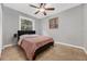 Cozy bedroom with tile floor, ceiling fan, and comfortable furnishings at 7838 Sloewood Dr, Mount Dora, FL 32757