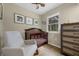 Cozy Bedroom with wood crib, neutral walls, and natural light from the window at 7838 Sloewood Dr, Mount Dora, FL 32757