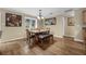Bright dining room with hardwood floors, a contemporary light fixture, and a view of the backyard at 7838 Sloewood Dr, Mount Dora, FL 32757