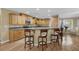 Charming eat-in kitchen featuring wood cabinets, stainless appliances and bar seating for casual dining at 7838 Sloewood Dr, Mount Dora, FL 32757