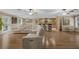 Open-concept living space with a kitchen and dining area with hardwood floors and modern lighting at 7838 Sloewood Dr, Mount Dora, FL 32757