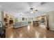 Spacious living room featuring a stone fireplace, hardwood floors, and seamless integration with the kitchen at 7838 Sloewood Dr, Mount Dora, FL 32757