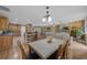 Open-concept living room with a stone fireplace, dining area, and an inviting kitchen and breakfast bar at 7838 Sloewood Dr, Mount Dora, FL 32757