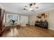 Cozy living space featuring a large window, hardwood floors, and stylish furnishings at 7838 Sloewood Dr, Mount Dora, FL 32757