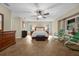 Spacious primary bedroom suite with tile floors, natural light, and comfortable seating at 7838 Sloewood Dr, Mount Dora, FL 32757