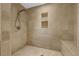 Walk-in shower features neutral stone tile and convenient built-in shelving and seating at 7838 Sloewood Dr, Mount Dora, FL 32757