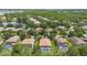 A scenic aerial view captures the neighborhood's serene blend of homes, lush greenery, and nearby lake at 9110 Stromboli Ct, Kissimmee, FL 34747
