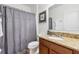 Bathroom showcasing a vanity with granite countertop, framed mirror, and shower with curtain at 9110 Stromboli Ct, Kissimmee, FL 34747