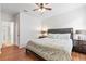 Spacious bedroom with dark wood furniture and an ensuite bathroom at 9110 Stromboli Ct, Kissimmee, FL 34747