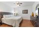 Bedroom featuring a dark wood bed frame, ceiling fan, and window at 9110 Stromboli Ct, Kissimmee, FL 34747