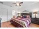 Comfortable bedroom featuring a ceiling fan, wood floors, and stylish decor at 9110 Stromboli Ct, Kissimmee, FL 34747