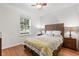 Bedroom with a woven headboard, ceiling fan and natural light from a window at 9110 Stromboli Ct, Kissimmee, FL 34747