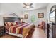 Bedroom with hardwood floors, complemented by dark wood furniture and decor at 9110 Stromboli Ct, Kissimmee, FL 34747