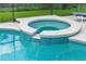 The hot tub has beautiful tile-work and is perfect for relaxing and entertaining outdoors at 9110 Stromboli Ct, Kissimmee, FL 34747