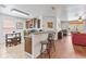 Open kitchen featuring dark wood cabinets, granite countertops, and bar seating at 9110 Stromboli Ct, Kissimmee, FL 34747