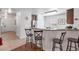 Kitchen with breakfast bar, granite countertops, stainless steel refrigerator, and tile backsplash at 9110 Stromboli Ct, Kissimmee, FL 34747