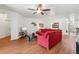 Bright living room with wood floors, a ceiling fan, and ample space for entertaining friends and Gathering at 9110 Stromboli Ct, Kissimmee, FL 34747