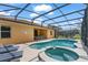 Relaxing outdoor pool with a spa and screened enclosure, seamlessly integrated with the backyard for enjoyment at 9110 Stromboli Ct, Kissimmee, FL 34747