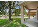 View of backyard featuring grassy area and a large tree at 1030 Bending Oak Trl, Winter Garden, FL 34787