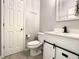 Stylish powder room with modern vanity, sliding door cabinet and matte black faucet at 1030 Bending Oak Trl, Winter Garden, FL 34787
