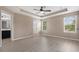 Spacious bedroom featuring tray ceiling, wood floors, and neighborhood views at 1030 Bending Oak Trl, Winter Garden, FL 34787