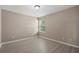 A bedroom features neutral paint, a ceiling light, wood-look floors, and a window at 1030 Bending Oak Trl, Winter Garden, FL 34787