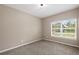 Bright bedroom with neutral walls, carpeted flooring, and a large window with neighborhood views at 1030 Bending Oak Trl, Winter Garden, FL 34787