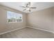 This bedroom features light gray floors and a window providing ample natural light at 1030 Bending Oak Trl, Winter Garden, FL 34787