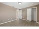 A bedroom features neutral paint, a ceiling light, wood-look floors, and a closet with an open door at 1030 Bending Oak Trl, Winter Garden, FL 34787
