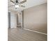 A bedroom featuring hard surface floors, a ceiling fan, and access to a closet and an interior door at 1030 Bending Oak Trl, Winter Garden, FL 34787