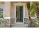 Inviting entryway featuring a green front door and a stone-accented facade at 1030 Bending Oak Trl, Winter Garden, FL 34787