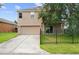 Exterior view of a two-story home with a two car garage and long driveway at 1030 Bending Oak Trl, Winter Garden, FL 34787